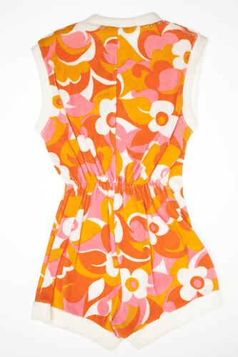 Jumpsuit with orange, pink and white floral design.