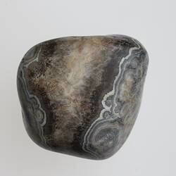 Agate pebble with black and white patterns.