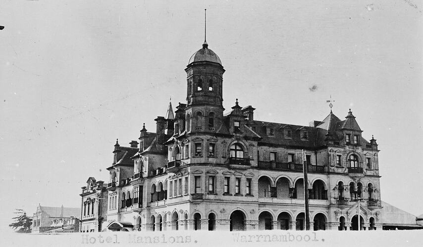 Prominent, ornate 3 storey corner building. Domed tower on corner of building.