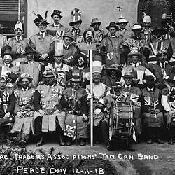 Seated and standing group in costume. Many wearing ' black face'. Some have instruments.