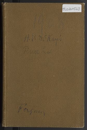 Front cover of a brown book with some faded writing.