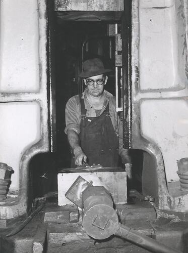 A man operating a drop hammer.