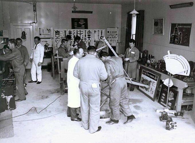 Group of men at work in workshop.