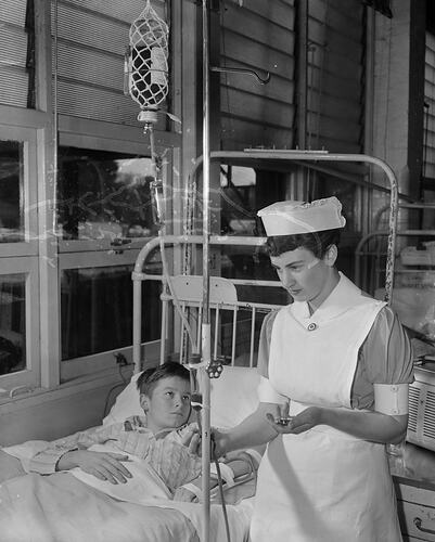 Boy in Hospital Bed with Nurse, Royal Children's Hospital, Melbourne, Victoria, 1956