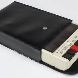 White cassette recorder in black case.