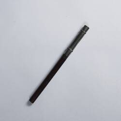 Pencil with painted wooden shaf and silver metal removable top.
