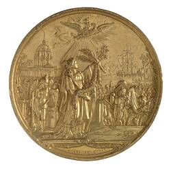 Round medal with central female figure holding up branches to the sky. Waterside city in background.