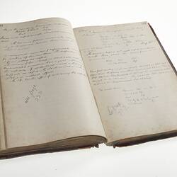 Open book with two pages of handwritten cursive text in ink.