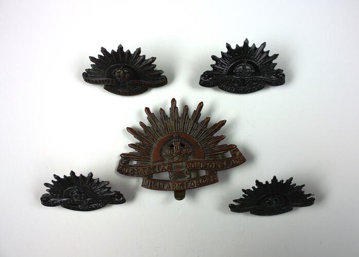 Metal badges, front view.