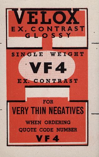 Red paper label with printed black text.