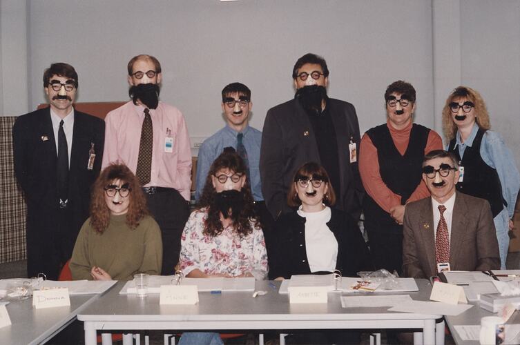 Group of people in Groucho Marx novelty masks.
