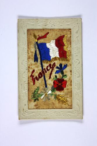 Front of postcard with embroidered flags.