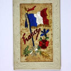 Front of postcard with embroidered flags.