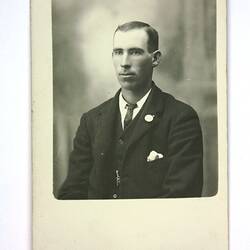 Upper body portrait of man in suit and tie.