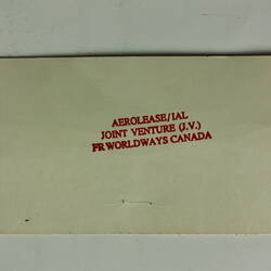 Red cylindrical container with two electrical cords at one end.