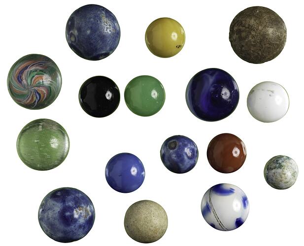 16 different sized and patterned glass marbles.