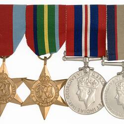 Group of four medals with ribbons joined together in a row.