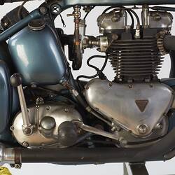 Blue metallic motor cycle. Engine detail, right profile.