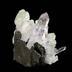 Tall purple crystal with smaller blocky green crystals.