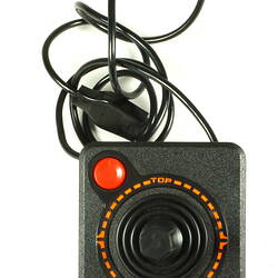 Overhead view of black plastic joystick and power cable.
