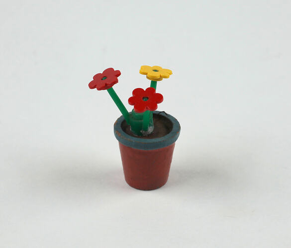 Plastic toy flower pot, upright.