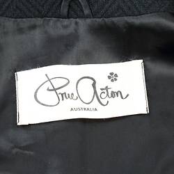Black silk lining with white maker's label. Label has black text.