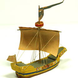 Three quarter view of ship with yellow hull and painted sail.