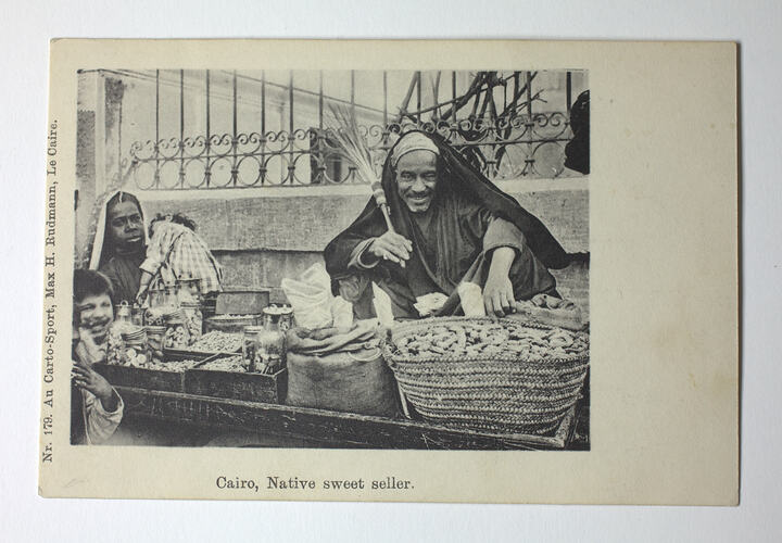 Street sellers with baskets and child.