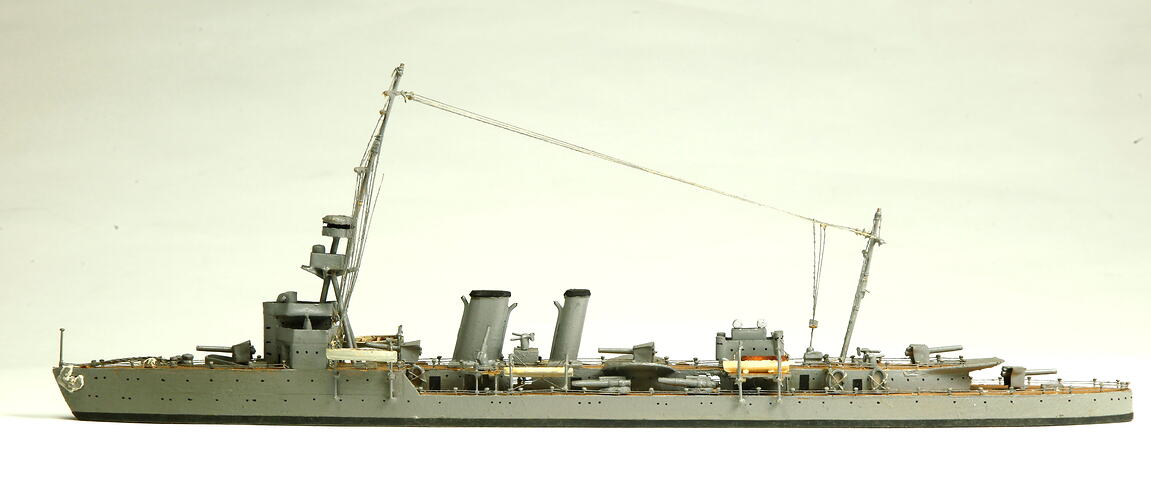 Naval ship with mast, facing left.