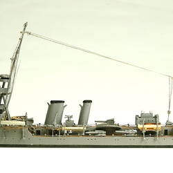 Naval ship with mast, facing left.