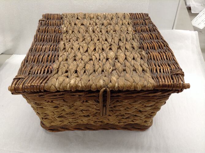 Square raffia and cane lidded basket.