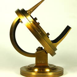 Side view of gold metal chronometer.