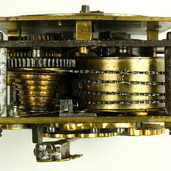 Internal mechanism of decorative table clock, square gilded brass case.