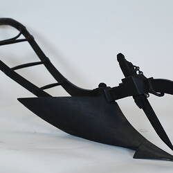 Handheld plough model with large blade, three quarter view.