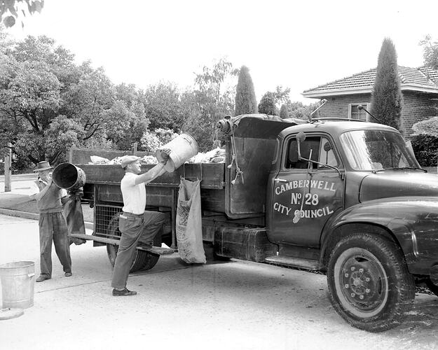 Garbage men loading rubbish into a Camberwell City Council truck, Camberwell, Victoria, circa 1960s