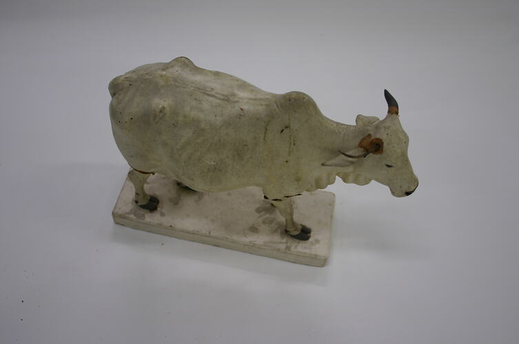Model of white cow in clay.