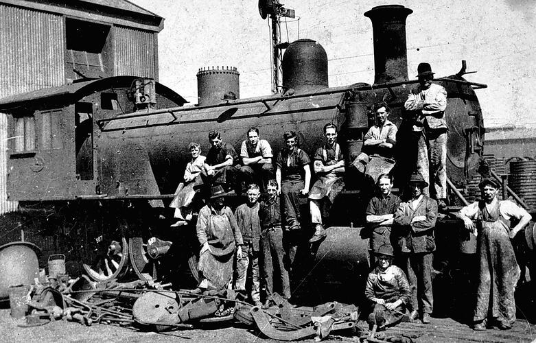 Staff maintaining locomotive, Newport railway workshop, 1920s.
