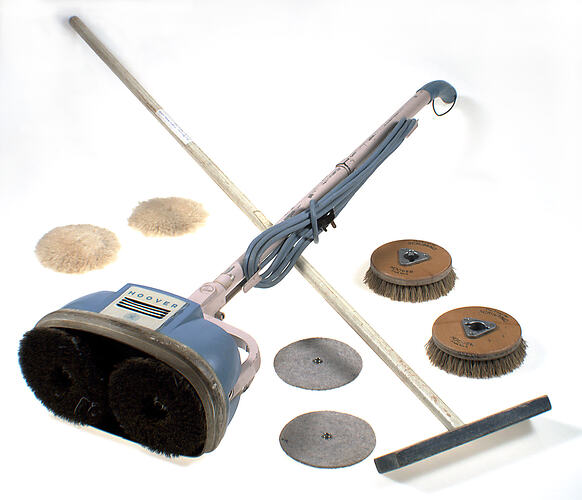 Floor polisher lying on side with accessories around.