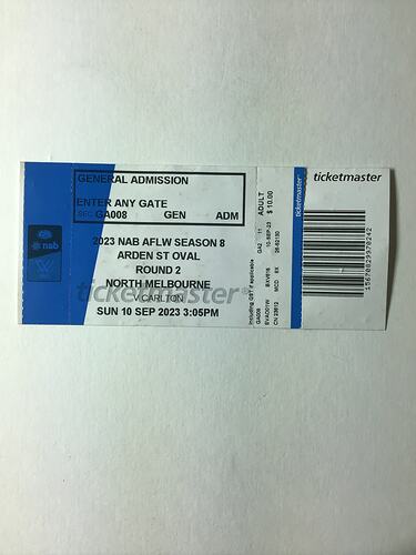 White and blue ticket with black printed text and barcode.