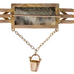 Reverse view of triple bar brooch with central quartz and gold specimen with small gold bucket attached.