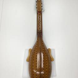 Back of brown wooden mandolin.