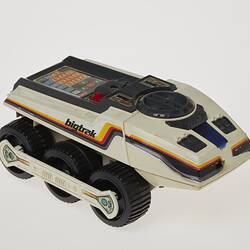 Cream six-wheeled toy truck. Stickers on sides. Right front three-quarter profile.