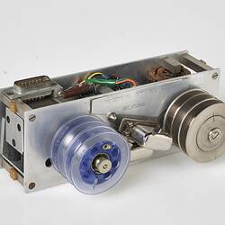 Small metal box two wired reels on top. One reel is blue plastic the other metal.