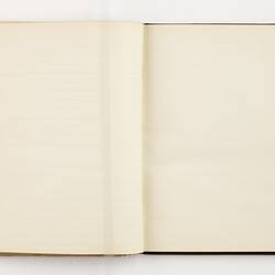 Open book with off white ruled pages.