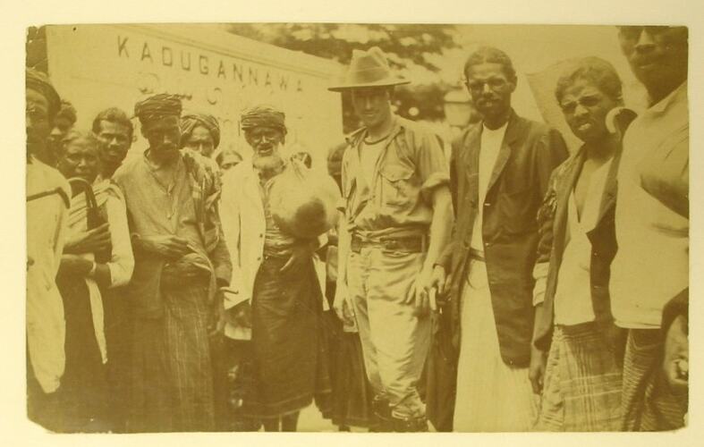 Australian soldier standing with group of Sri Lanken men and women.