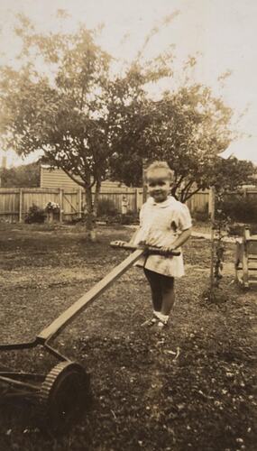 Digital Photograph - 'I'm a great help to daddy ...' Child Attempting to Mow Lawn, Preston East, 1944-1945