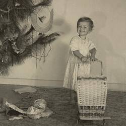 Digital Photograph - Smiling Girl with New Toy Wicker Pram, Living Room, Nunawading, Christmas 1952