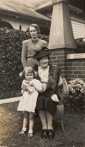 Digital Photograph - Two Women with World War 2 'Female Relatives' Badges & Girl, Front Garden, Brunswick West, 1943