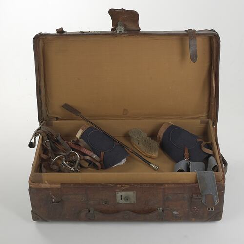 Suitcase containing horse racing equipment.