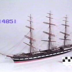 fully rigged wooden model of a ship.